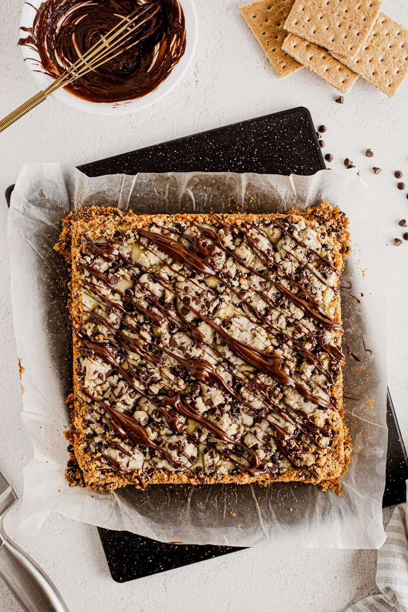 Overhead view of chocolate chip cookie dough cheesecake bars before cutting