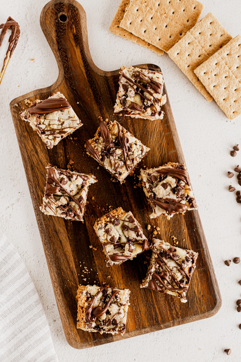 Overhead view of cookie dough cheesecake bars on cutting board