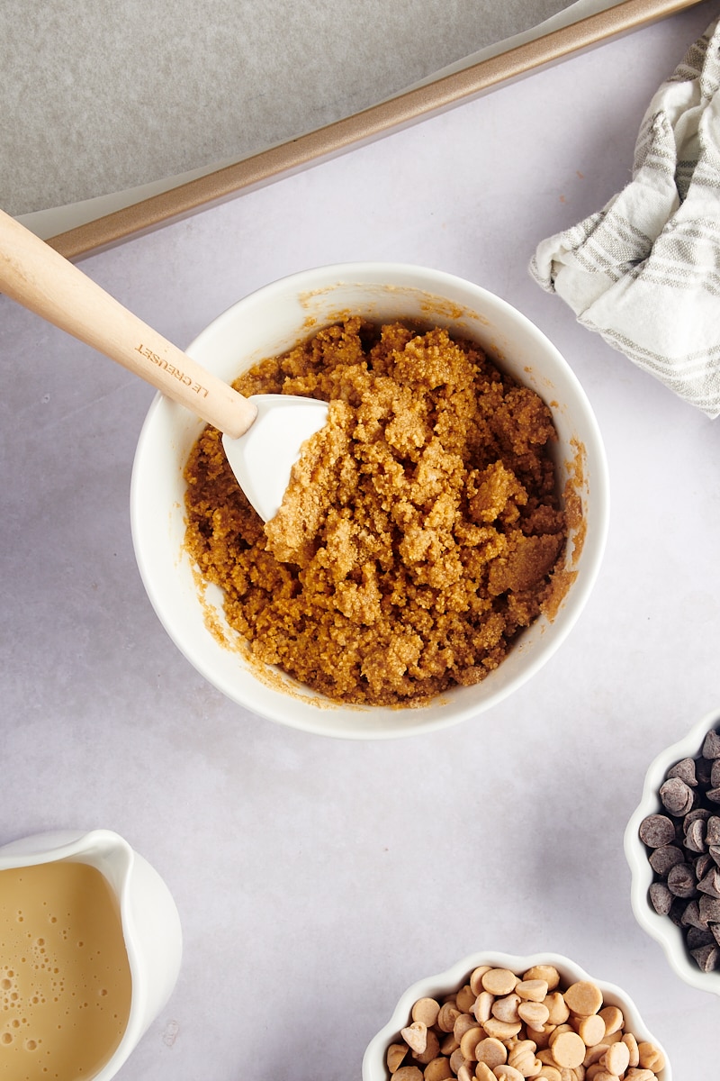 Overhead view of graham cracker crust mixture in bowl