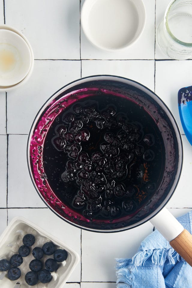 overhead view of blueberry compote in a white saucepan