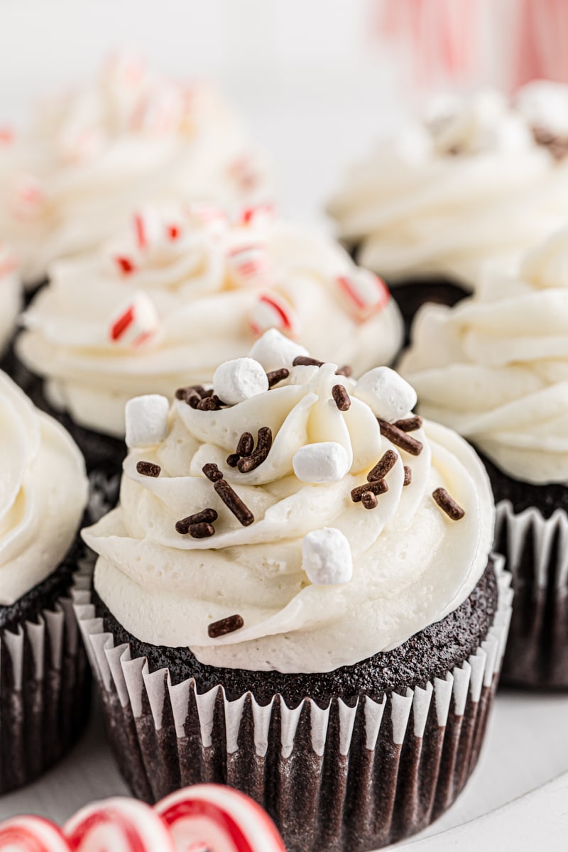 hot chocolate cupcakes on a white cake stand