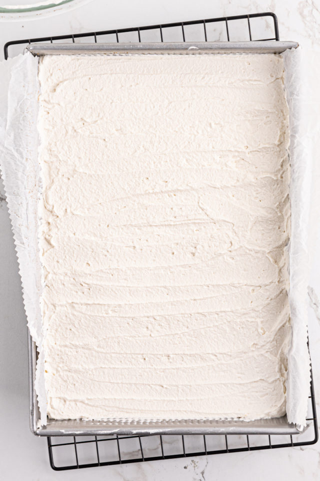 overhead view of key lime pie bars topped with whipped cream